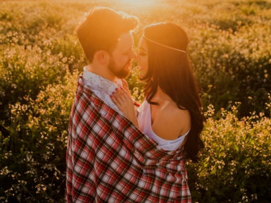man hugging woman surrounded by plants